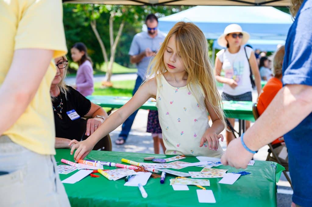 girl doing arts and crafts outside at Art Fest in Farragut