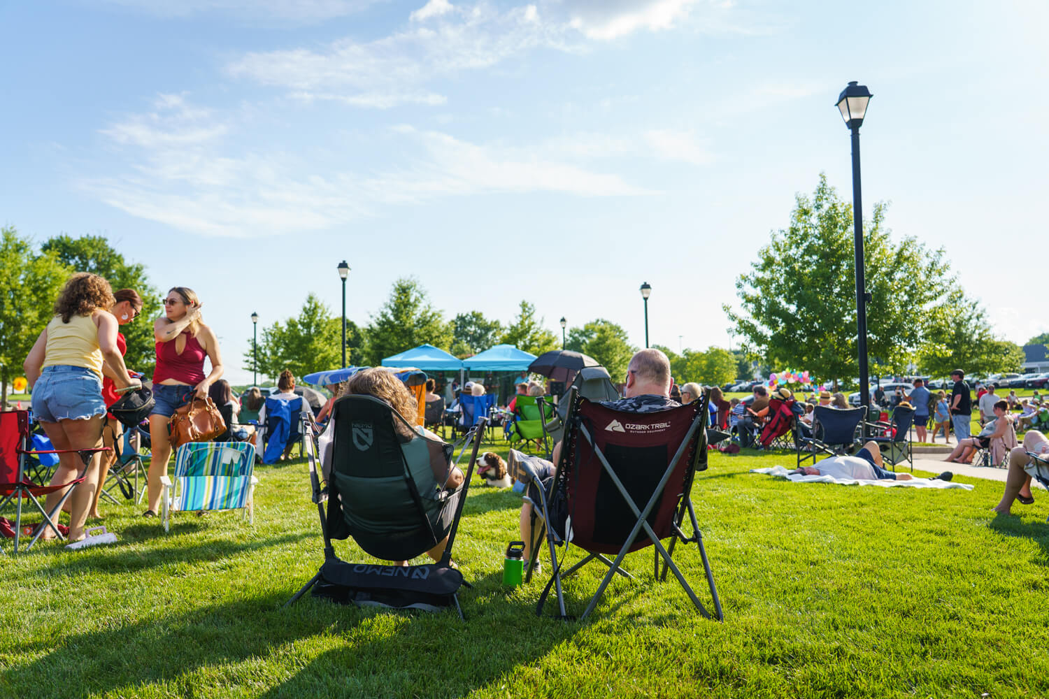 Two people in chairs at Bluegrass concert at McGil Plaza