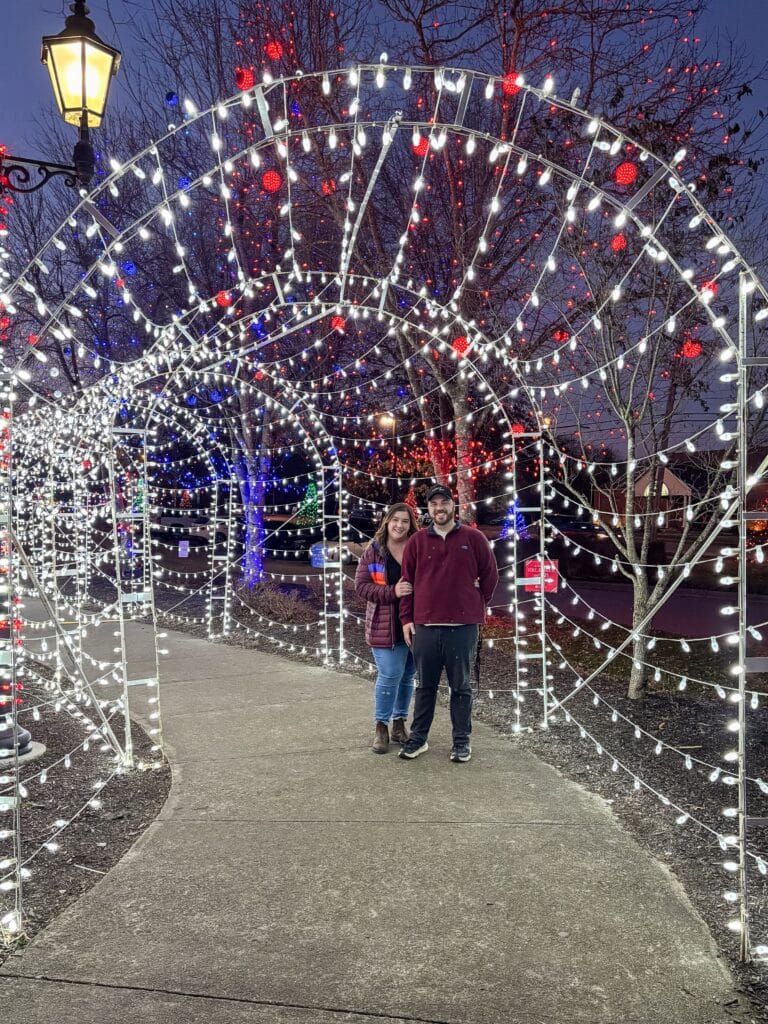Couple smiling under lights at founders park christmas holiday couple farragut tn