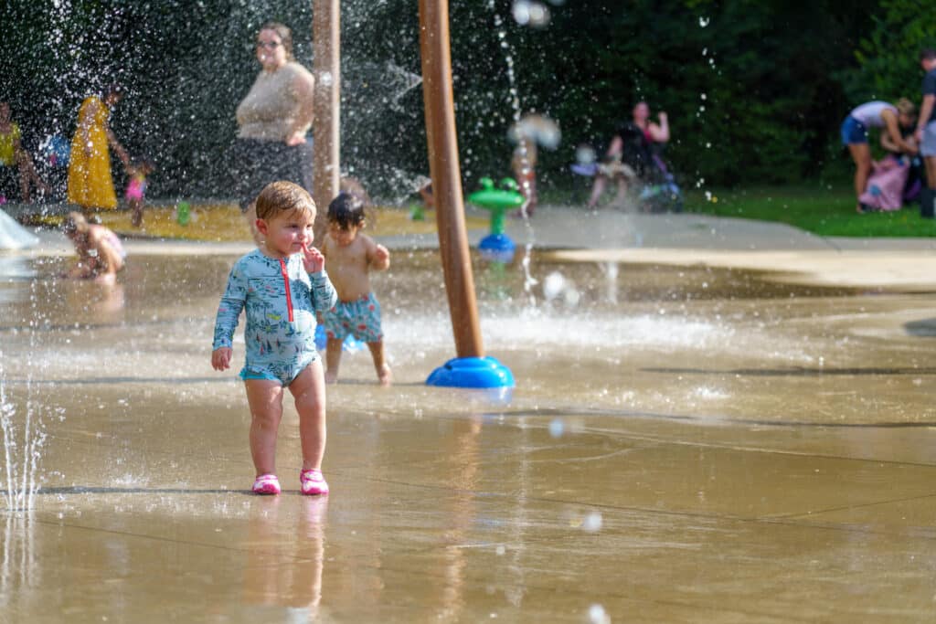 Baby playing in the splash pad at McFee park during Party in the Park in Farragut, TN