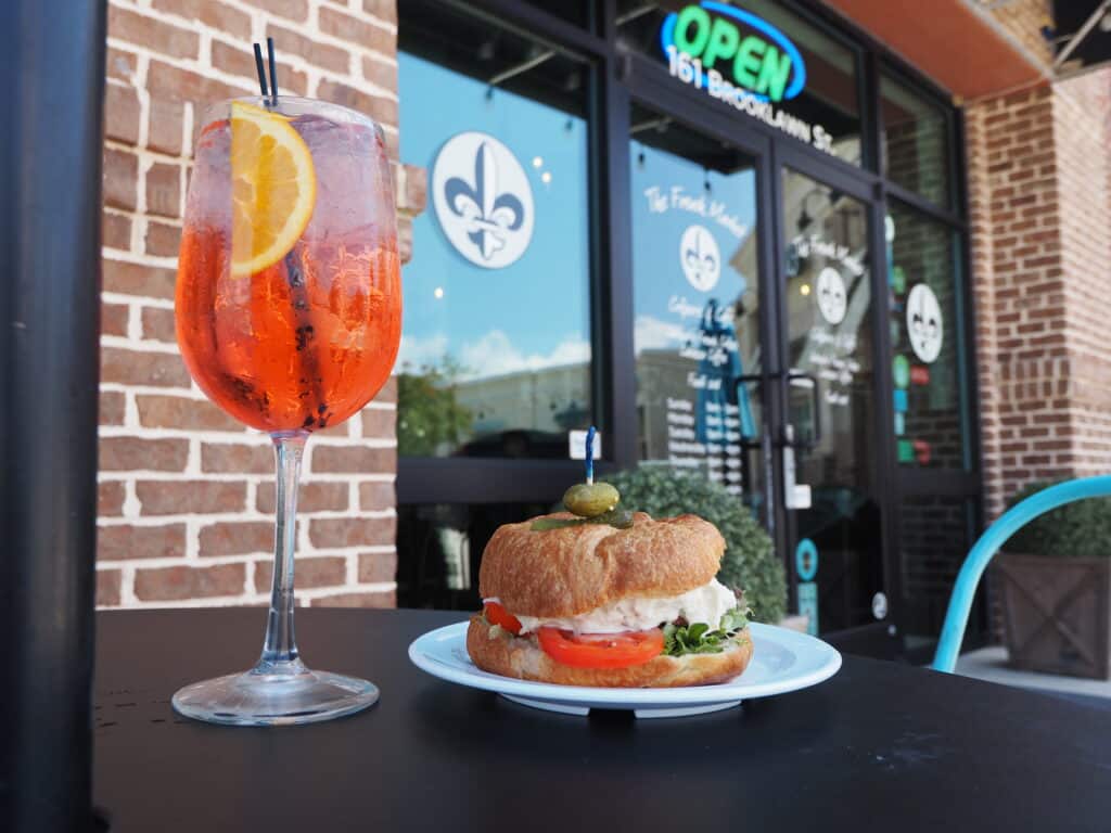 French Market Creperie Brunch Lunch Aperol Spritz Chicken Salad on the patio outdoors