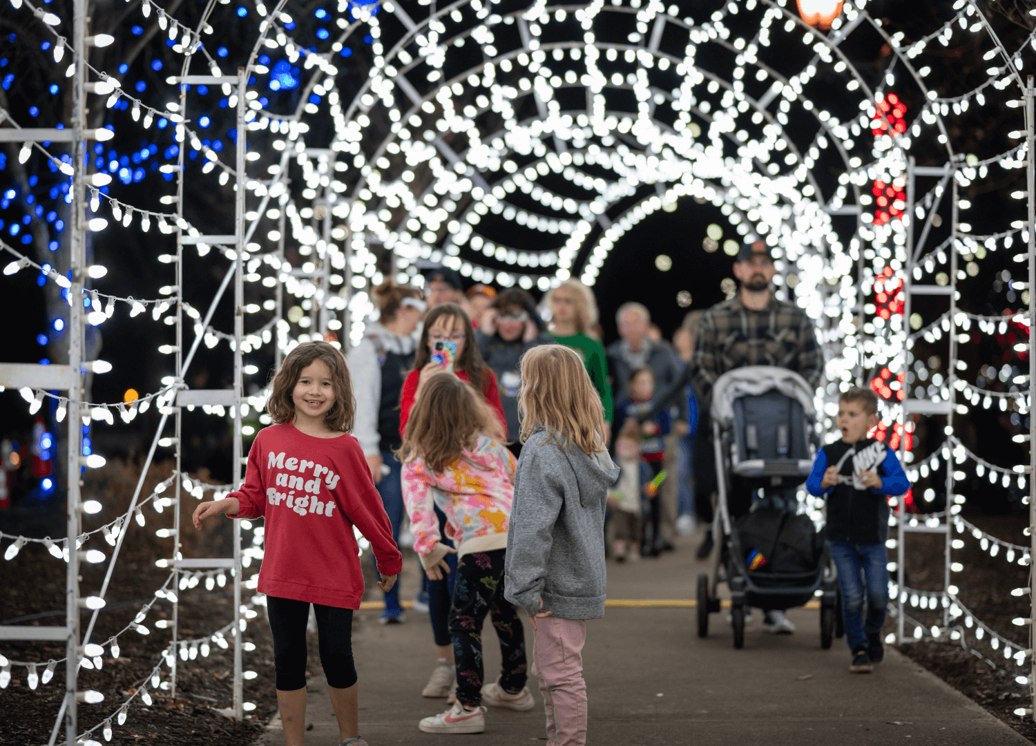 families walking through tunnel of lights at Countdown to Light the Park