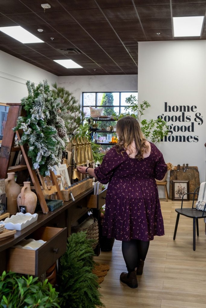 woman walking through Park + Alley, a stylish home good shop