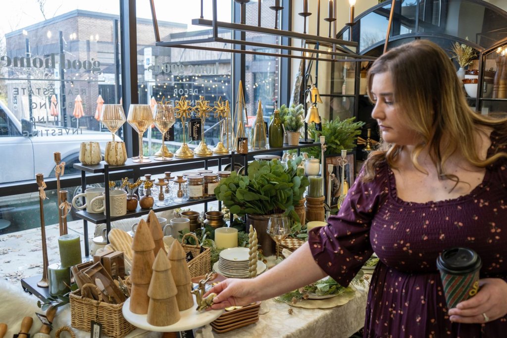 a decorative display of greenery, table decor, candles, and a variety of other home decor